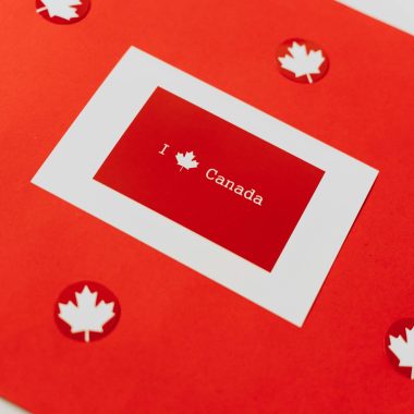 Artistic red card with maple leaves celebrating Canadian patriotism and decoration.